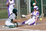 Lemoor's Shelly Jobe slides into home during Thursday's 8-2 victory over visiting Dinuba. Jobe went two for three in the game to lead the Tigers.